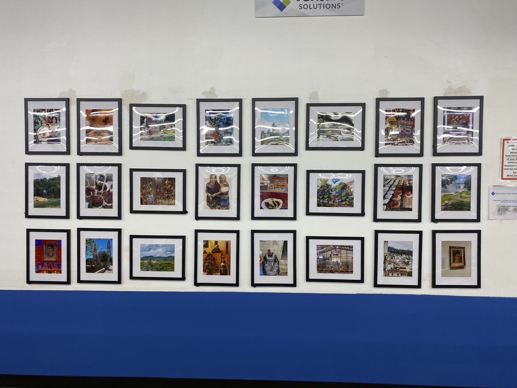 Photos for the Hispanic Heritage Month challenge displayed on a wall in the Monroe facility