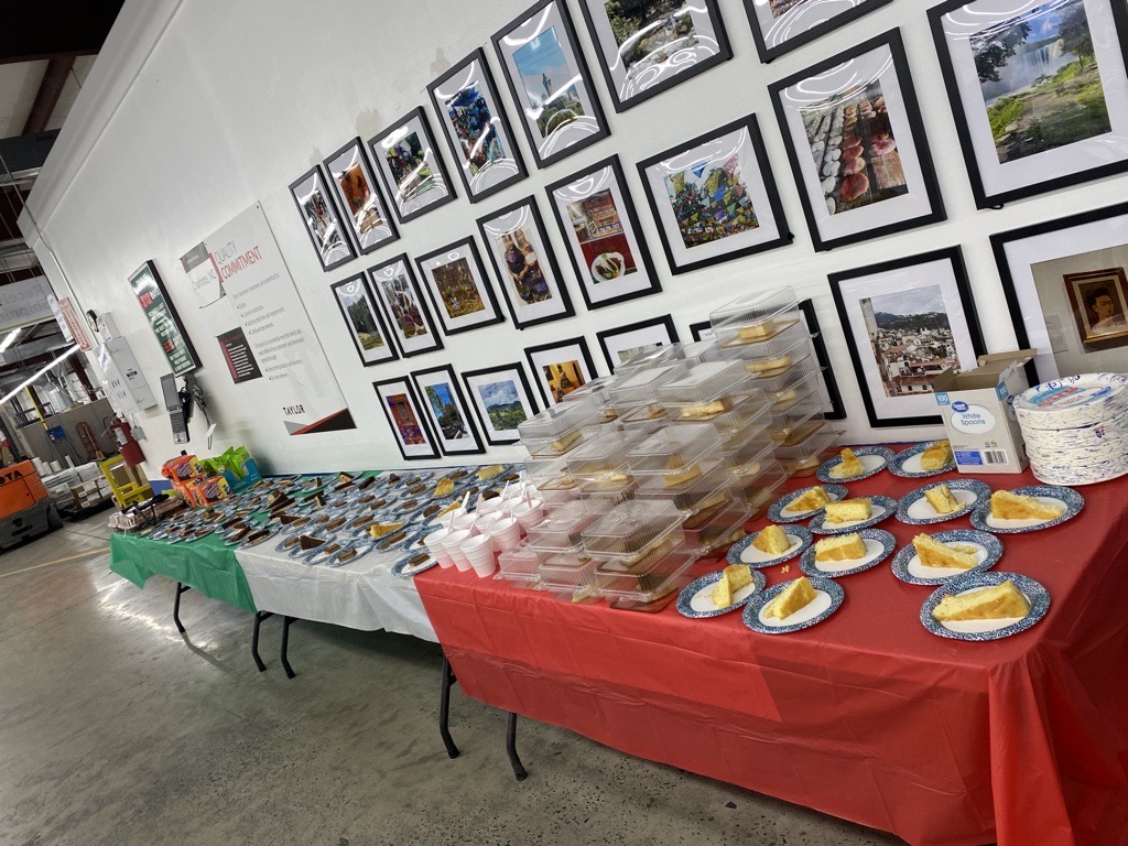 An assortment of desserts, snacks, and other treats laid out on tables in front of the photo challenge wall